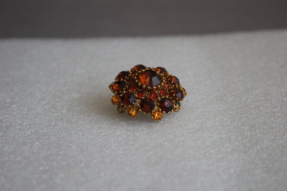Image 1 of Vintage costume jewelry brooch with amber rhinestones, marked SPHINX