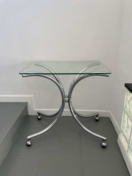 Salontafel van chroom en glas met wielen