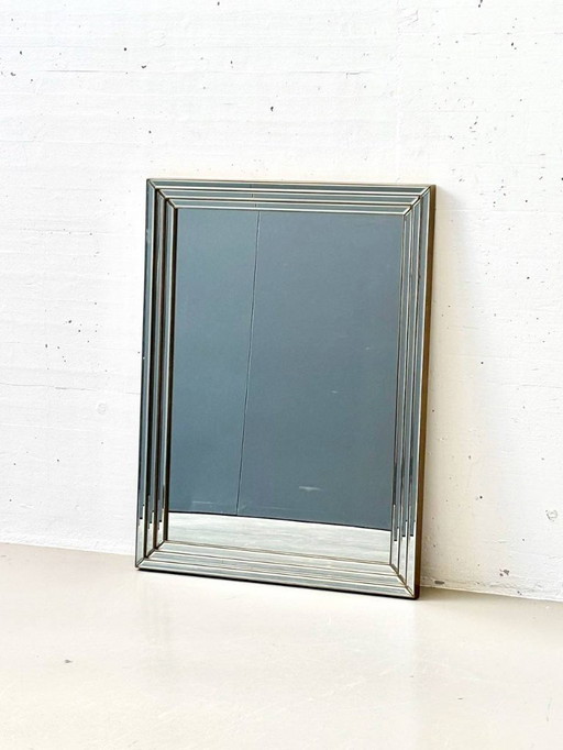 Wall mirror framed with faceted mirror glass