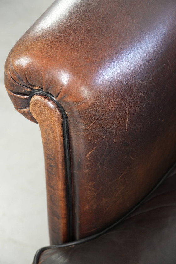Image 1 of Dark sheepskin club armchair with a unique design and a desirable English-style patina.