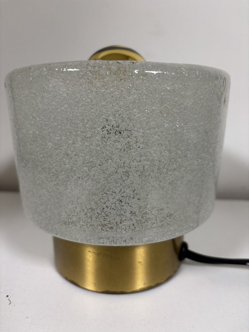 vintage table lamp by Peill & Putzler is made of thick ice glass with brass details