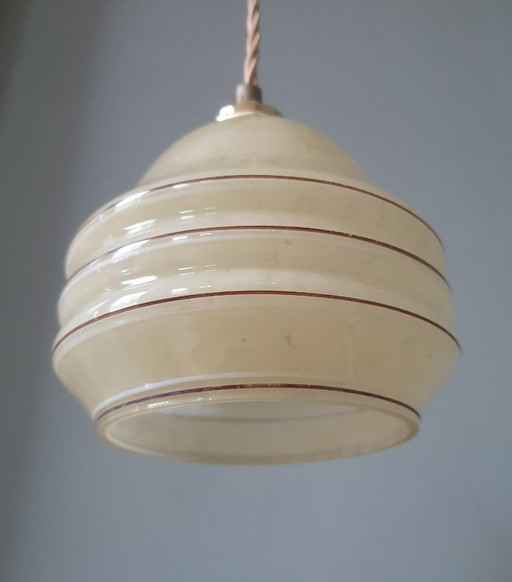 Vintage pendant lamp - amber-colored glass with spotlights and gold-colored stripes.