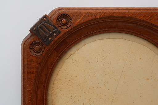 Art nouveau oak photo frame with copper decorations by Geo Verbanck