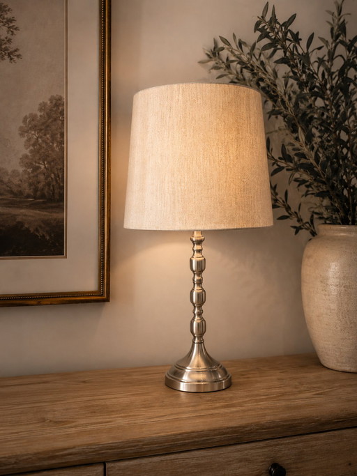 Elegant metallic table lamp with textured beige shade