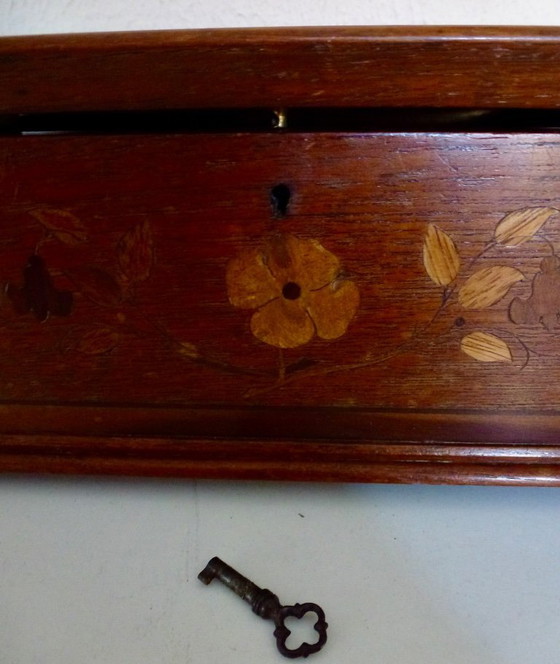 Image 1 of Una scatola di legno d'epoca con intarsi floreali