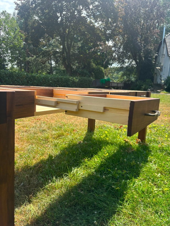 Image 1 of Dining table in American walnut and maple. Handcrafted solid wood extensions and drawers. Live edge for visual depth. Epoxy resi