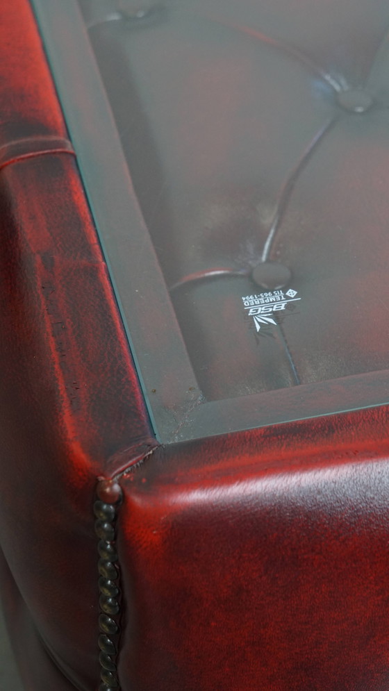 Image 1 of Beef leather chesterfield side/ coffee table in a red color with glass top