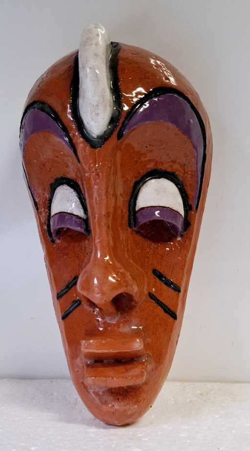 African mask made of ceramic .