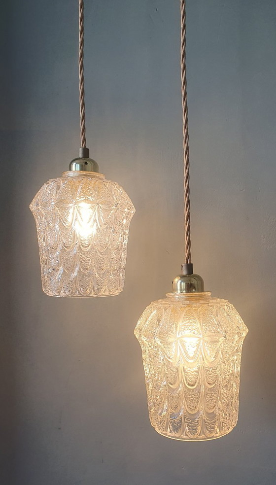 Image 1 of Set of two vintage Mic Century pendant lamps of thick, textured glass.