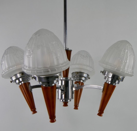 Image 1 of Chrome Art Deco chandelier with four amber Bakelite torches with decorated glass lampshades, ca. 1935