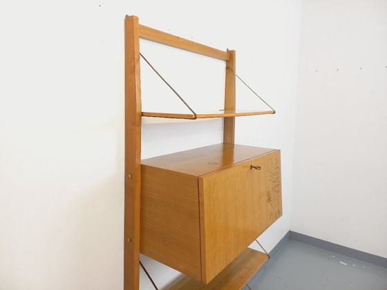 Image 1 of Wall-mounted bookcase with vintage light wood and brass secretary bar, dating from the 1960s
