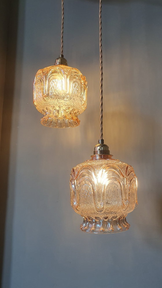 Image 1 of Set of 2 Vintage textured rose / amber tinted pendant lamps - mid-century design.