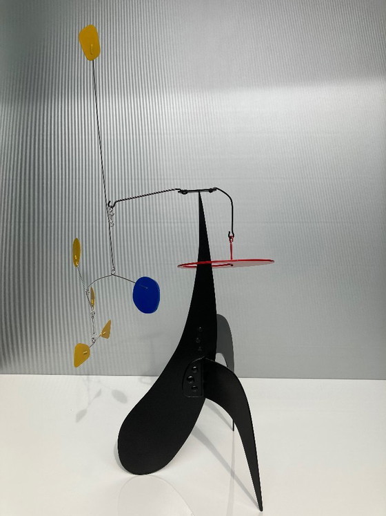 Image 1 of 5 Yellow And 1 Blue on a black stabile