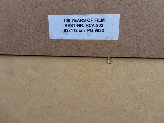 Image 1 of Een kunstreproductie van het schilderij "100 Years of Film” van kunstenaar Renato Casaro.