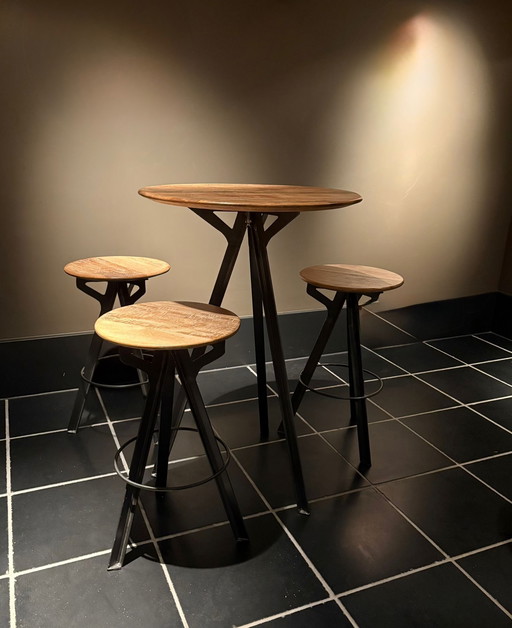 High wooden table with 3 stools