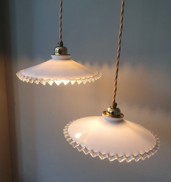 Image 1 of 2 vintage hanglampen van wit opaline glas met een transparante sierrand.