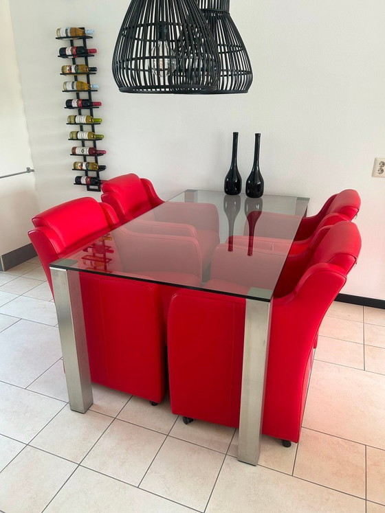 Image 1 of Glass dining table and red chairs (on wheels) by Eijerkamp
