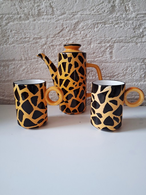 Ceramic coffee pot with 2 mugs in giraffe print, also nice for chocolate milk.