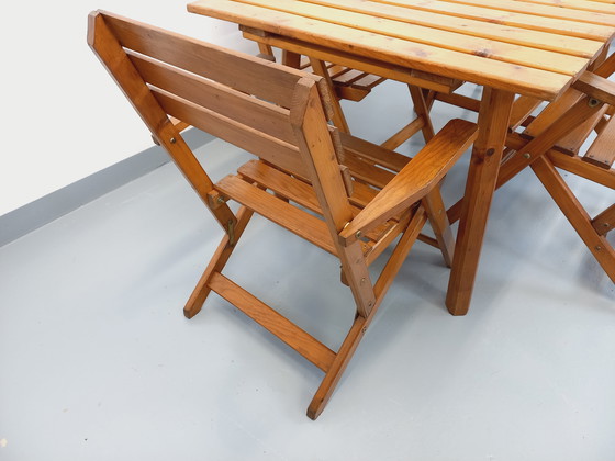 Image 1 of Vintage garden furniture consisting of a table with extensions and 4 wooden armchairs from the 60s