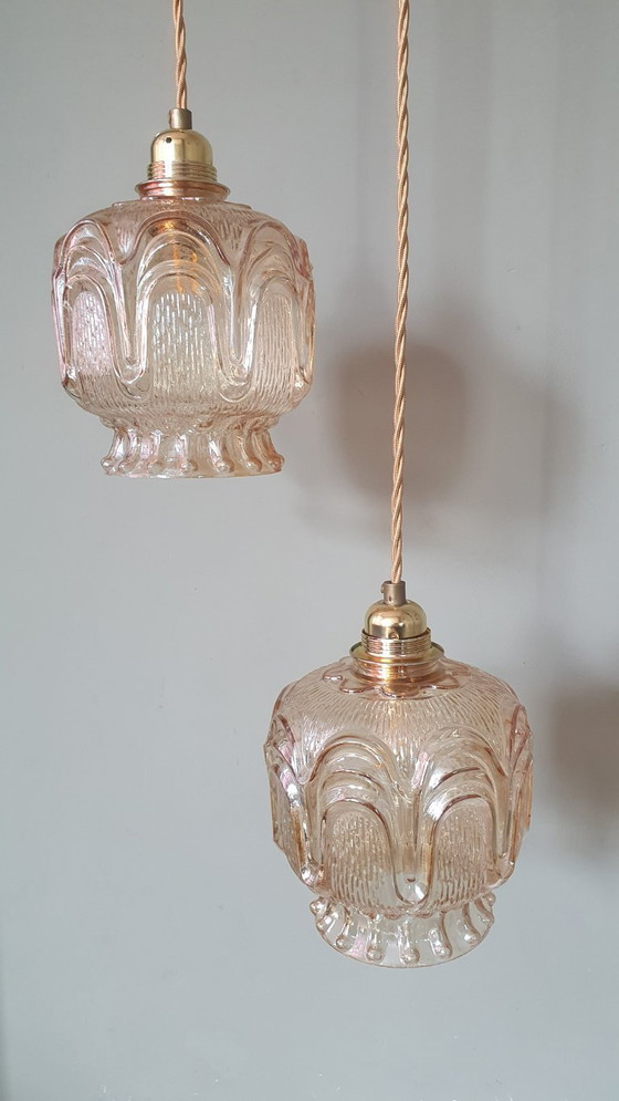 Image 1 of Set of 2 Vintage textured rose / amber tinted pendant lamps - mid-century design.