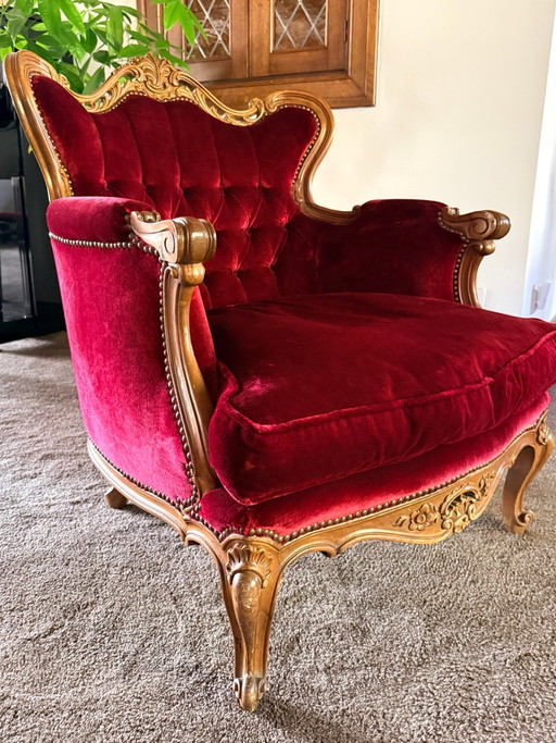 Classic antique armchair, red velvet, ornate wooden frame