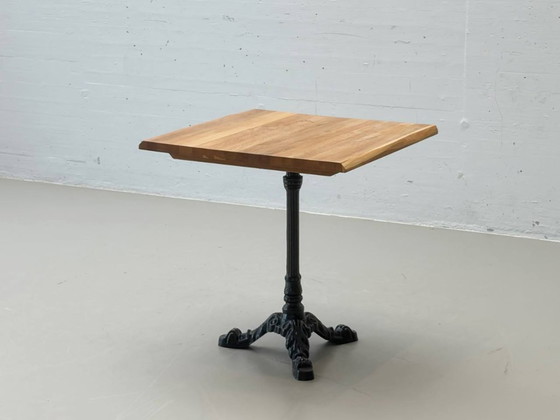 Image 1 of Bistro table made of acacia wood with a cast iron base in country style