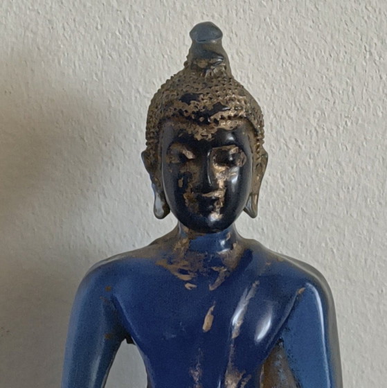 Image 1 of Old Buddha made of blue glass and stone material.