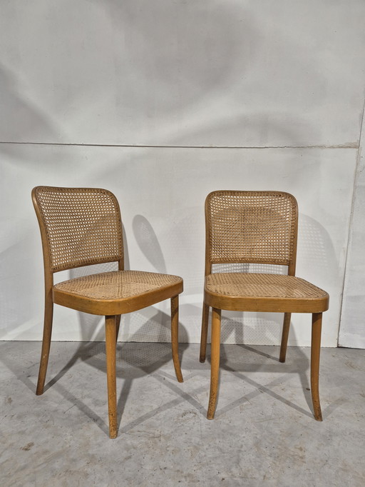 Un par de sillas vintage Ligna con asiento de cincha.