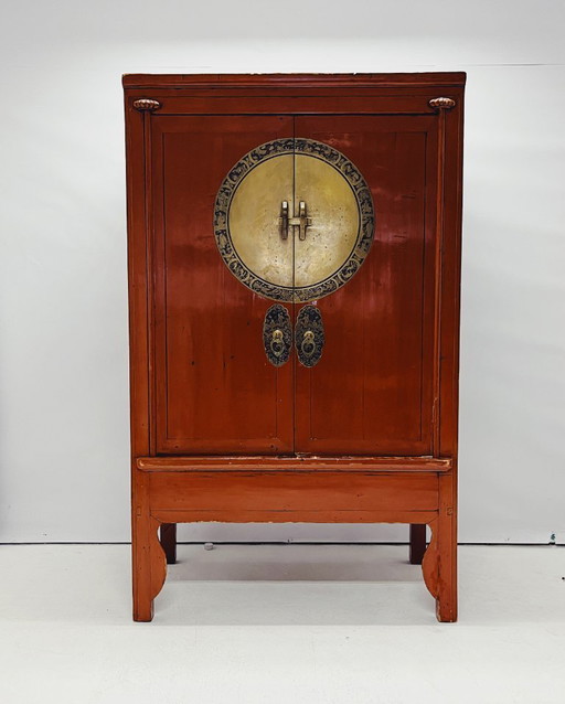 Antique red cabinet with brass details