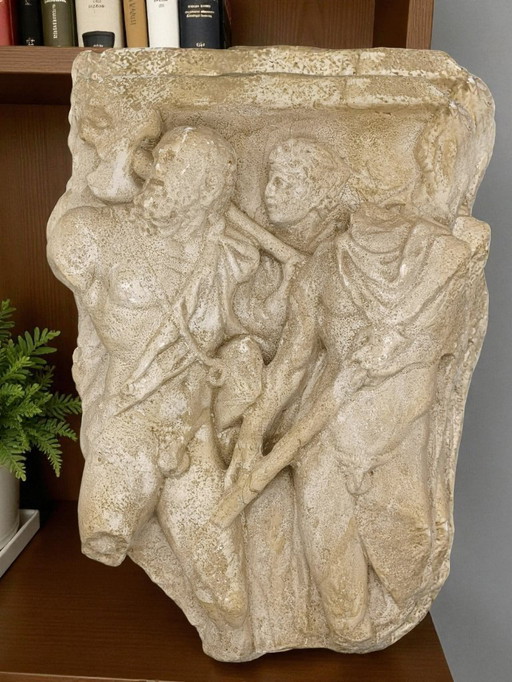 high-relief plaster sculpture depicting an ancient scene