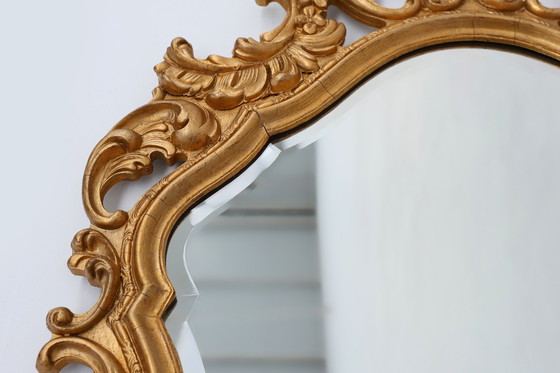 Image 1 of French Rococo or Baroque style facet-cut crest mirror in gilded carved wood