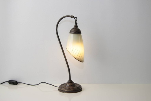 Vintage brass table lamp with curved arm and glass shade