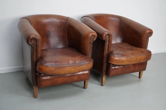 Image 1 of Vintage Nederlandse leren clubfauteuils in cognackleur, set van 2 met voetenbank