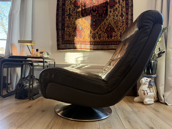 Image 1 of Dark brown vintage leather lounge armchair – timeless luxury and character