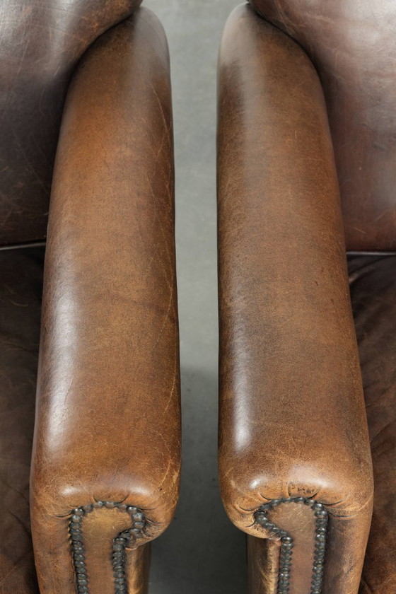 Image 1 of 2 fauteuils design en peau de mouton avec une belle patine