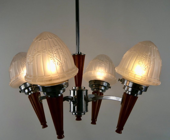 Image 1 of Chrome Art Deco chandelier with four amber Bakelite torches with decorated glass lampshades, ca. 1935