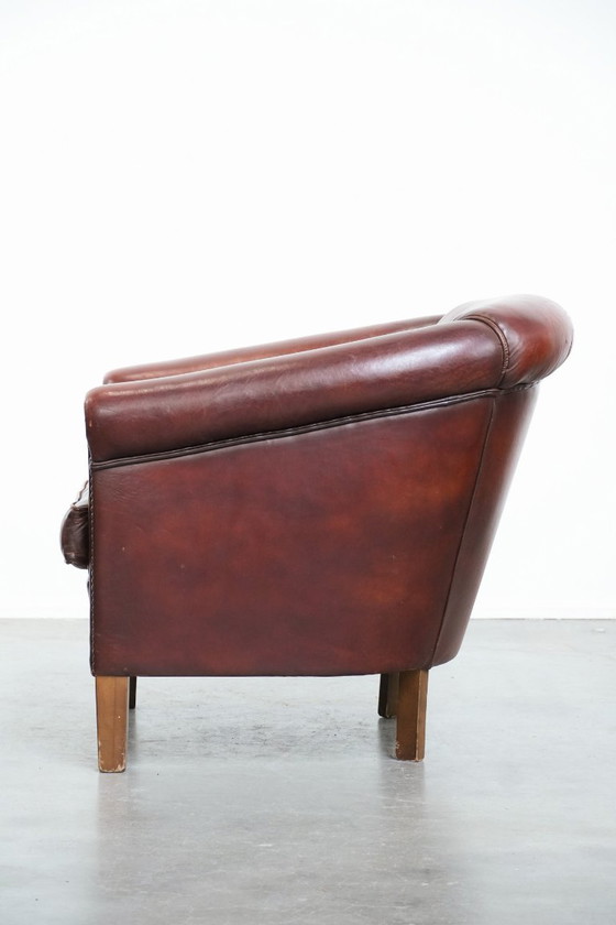 Image 1 of Vintage clubfauteuil gemaakt van schapenleer met siernagels