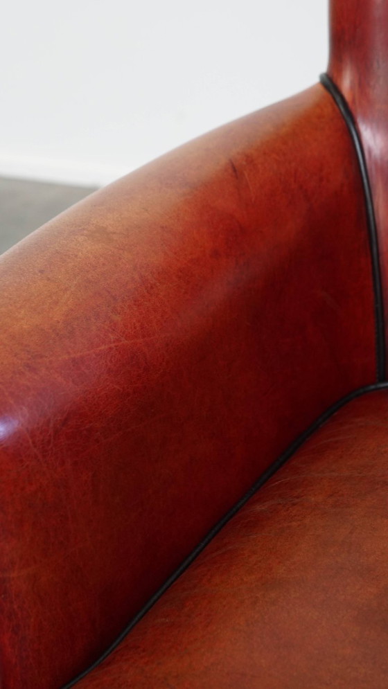 Image 1 of Fauteuil gemaakt van schapenleer in een rood/ bruine kleur