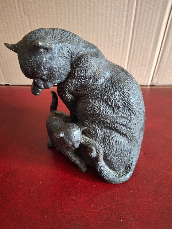 Image 1 of Escultura de bronce de un gatito jugando con la cola de un gato.