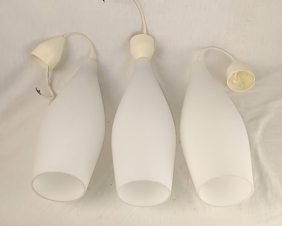 Image 1 of Elegant and timeless, this set of three original Holmegaard glass pendant lamps