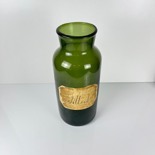 Large antique apothecary bottle in green blown glass