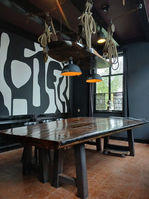 Robust ship's table with ceiling piece, accessories, and lamps for 18 people