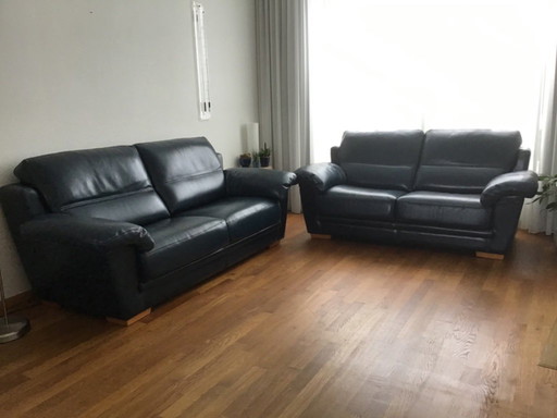 2 blue leather sofas