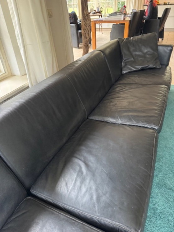 Image 1 of 4-seater black thick leather sofa, divisible with side table