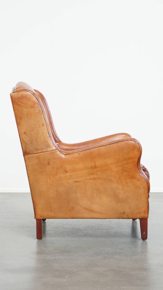 Image 1 of Schapenleren armchair met hoge rug en zwarte biezen 