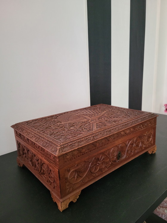 Image 1 of Hand-engraved wooden jewelry box with peacock and floral motifs.