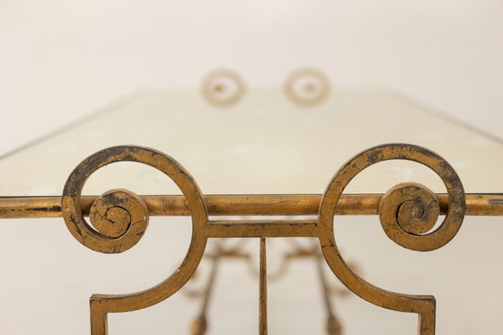 Image 1 of Table basse en fer forgé doré et plateau de verre églomisé. Années 1970