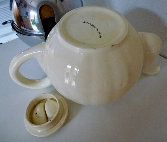 Image 1 of Ceramic Teapot with thermal Chrome casing which keeps the contents hot (or cold).