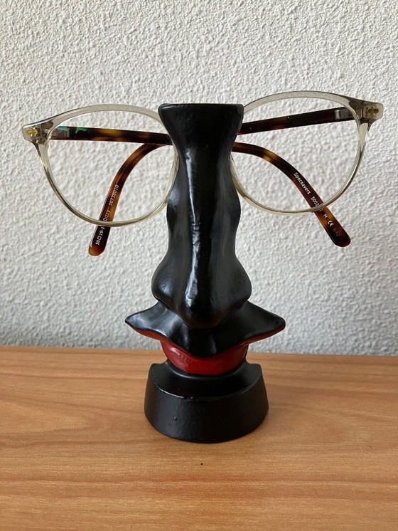 Image 1 of Salvador Dali glasses stand. Familiar design nose with mustache and lips.