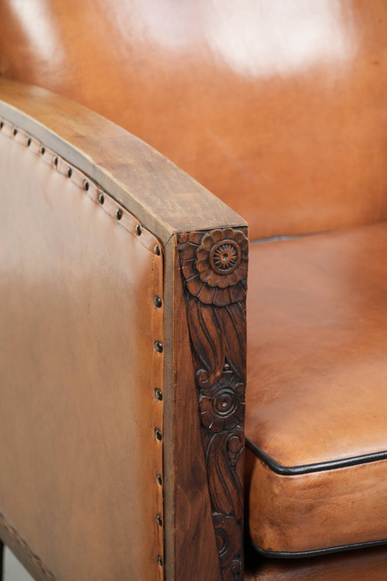 Image 1 of Schapenleren art Deco fauteuil met mooi houtsnijwerk en zwarte biezen